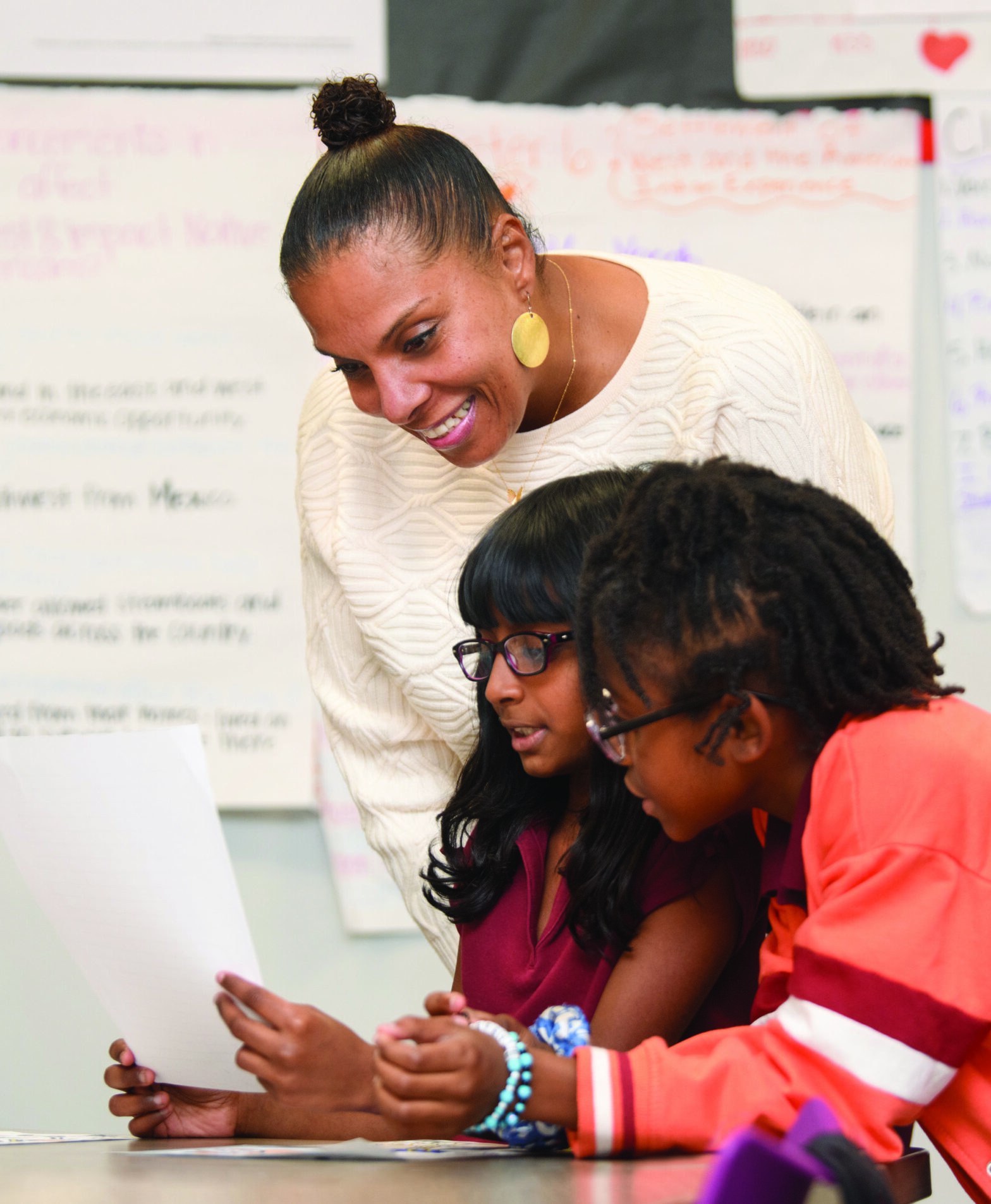 Angel Nelson visits with students during Boys & Girls Club activities at an elementary school in Baton Rouge.